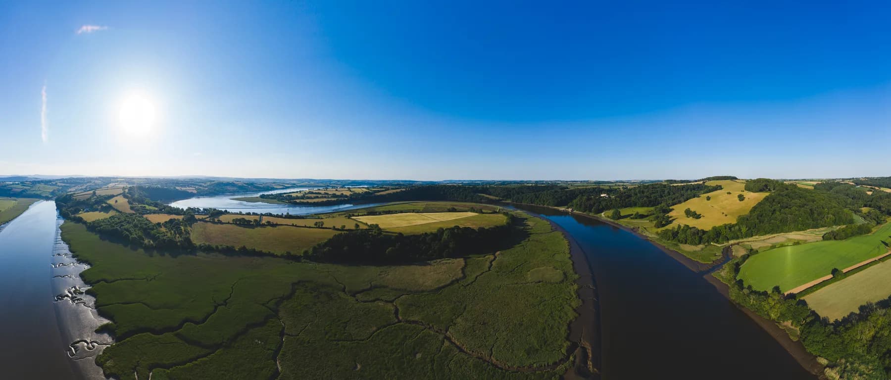 The River Tamar between wooded hills and farmland