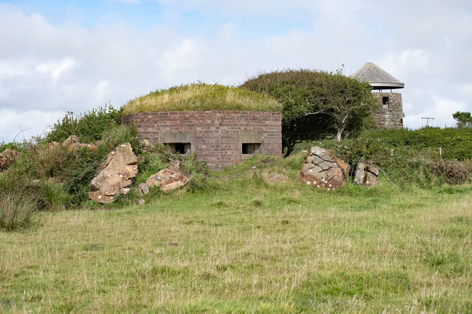 A wartime pillbox, with the windmill tower beyond.